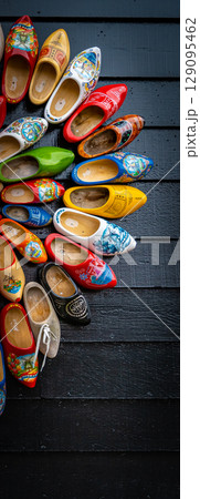 Clogs for sale at a Dutch retail shop. Wooden shoes are a well know traditional souvenir from Holland 129095462