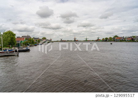 Rural landscape with windmill in Zaanse Schans. Holland, Netherlands. Authentic Zaandam mill. Beautiful Netherland landscape. 129095517