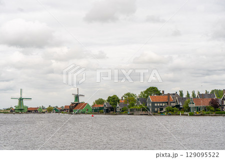 Rural landscape with windmill in Zaanse Schans. Holland, Netherlands. Authentic Zaandam mill. Beautiful Netherland landscape. 129095522