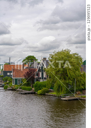Rural landscape with windmill in Zaanse Schans. Holland, Netherlands. Authentic Zaandam mill. Beautiful Netherland landscape. Rural landscape with windmill in Zaanse Schans. Holland, Netherlands. Authentic Zaandam mill. Beautiful Netherland landscape. 129095523