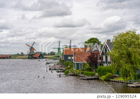 Rural landscape with windmill in Zaanse Schans. Holland, Netherlands. Authentic Zaandam mill. Beautiful Netherland landscape. Rural landscape with windmill in Zaanse Schans. Holland, Netherlands. Authentic Zaandam mill. Beautiful Netherland landscape. 129095524