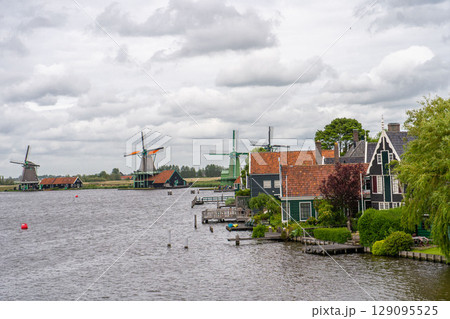 Rural landscape with windmill in Zaanse Schans. Holland, Netherlands. Authentic Zaandam mill. Beautiful Netherland landscape. 129095525