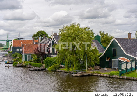 Rural landscape with windmill in Zaanse Schans. Holland, Netherlands. Authentic Zaandam mill. Beautiful Netherland landscape. Rural landscape with windmill in Zaanse Schans. Holland, Netherlands. Authentic Zaandam mill. Beautiful Netherland landscape. 129095526