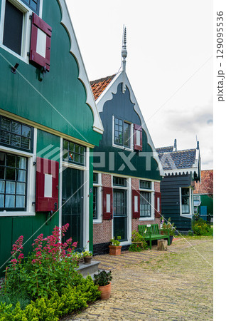 Authentic Zaandam mills on the water channel in Zaanse Schans willage. Zaanse Schans Windmills and famous Netherlands canals, Europe. Authentic Zaandam mills on the water channel in Zaanse Schans willage. Zaanse Schans Windmills and famous Netherlands canals, Europe. 129095536