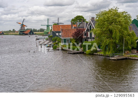 Rural landscape with windmill in Zaanse Schans. Holland, Netherlands. Authentic Zaandam mill. Beautiful Netherland landscape. 129095563