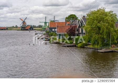 Rural landscape with windmill in Zaanse Schans. Holland, Netherlands. Authentic Zaandam mill. Beautiful Netherland landscape. 129095564