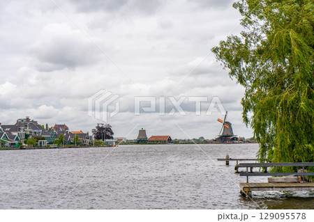 Rural landscape with windmill in Zaanse Schans. Holland, Netherlands. Authentic Zaandam mill. Beautiful Netherland landscape. 129095578