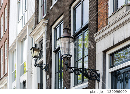 Details and facades of Amsterdam characteristic brick construction of residential building in Amsterdam School style. High quality photo 129096009