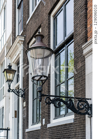 Details and facades of Amsterdam characteristic brick construction of residential building in Amsterdam School style. High quality photo Details and facades of Amsterdam characteristic brick construction of residential building in Amsterdam School style. High quality photo 129096010