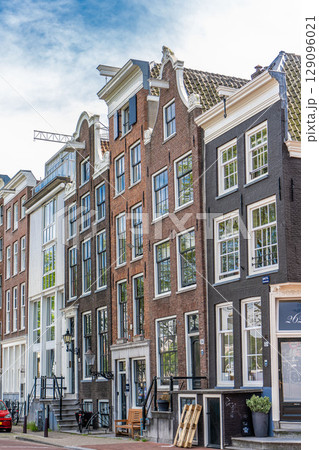 Details and facades of Amsterdam characteristic brick construction of residential building in Amsterdam School style. High quality photo 129096021