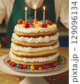 Birthday cake with colorful candles and candies close-up 129096134