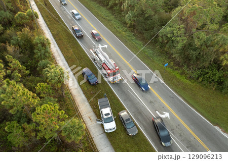 Car crash with first responders helping at accident site on American street. Vehicle collision on road in USA 129096213