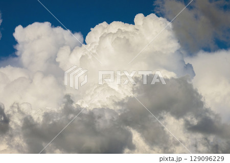 Bright landscape of blue sky with flying white clouds. Colorful summer skyscape Bright landscape of blue sky with flying white clouds. Colorful summer skyscape 129096229