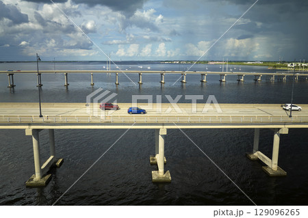 Barron Collier Bridge and Gilchrist Bridge in Florida with moving traffic. Transportation infrastructure in Charlotte County connecting Punta Gorda and Port Charlotte over Peace River 129096265