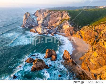 Ursa Beach, Cliffs and Atlantic Ocean Waves at Sunset. Portugal. Aerial View 129096407