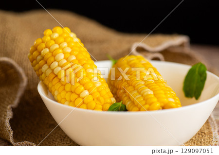 corn cobs with greenery on the table corn cobs with greenery on the table 129097051