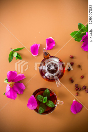 Aesthetic serving of tea with rosehip, petals and mint greens Aesthetic serving of tea with rosehip, petals and mint greens 129097082