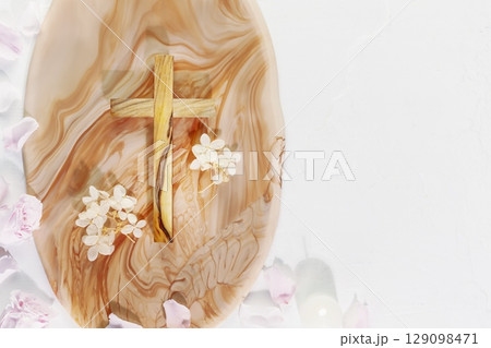 Wooden cross with flowers, rose petals and candles on marble podium on white background with copy space. Religious church holidays. Christianity Feast, Easter, Palm Sunday, Christening, church wedding 129098471