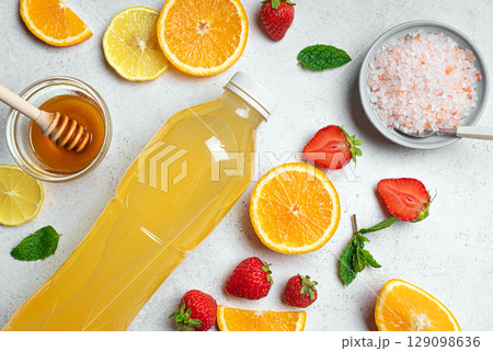 Isotonic sport drink bottle with fruits, honey and salt Isotonic sport drink bottle with fruits, honey and salt 129098636
