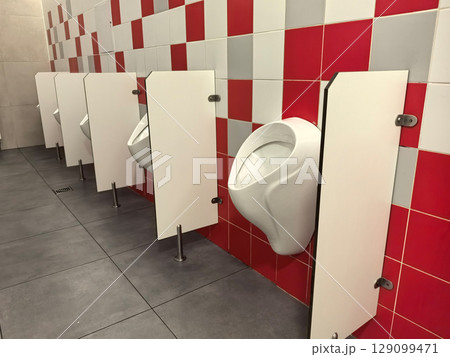 Modern restroom design showcases creativity with vibrant red tiles 129099471