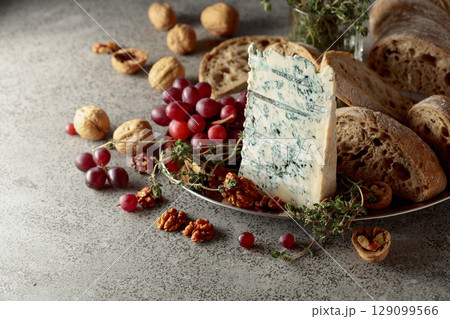 Gorgonzola with ciabatta, walnuts, red grapes, and thyme. Gorgonzola with ciabatta, walnuts, red grapes, and thyme. 129099566