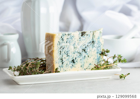 Gorgonzola and thyme on a white table. Gorgonzola and thyme on a white table. 129099568
