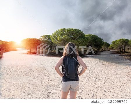 Woman choosing a path in a forest. Concept of decision making in life. 129099743
