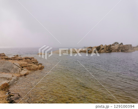 Idyllic landscape of a lagoon in a foggy environment, in Lagoa Comprida, Serra da Estrela, Portugal 129100394