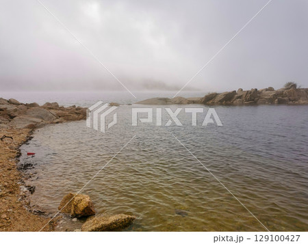 Idyllic landscape of a lagoon in a foggy environment, in Lagoa Comprida, Serra da Estrela, Portugal 129100427