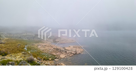 Idyllic landscape of a lagoon in a foggy environment, in Lagoa Comprida, Serra da Estrela, Portugal 129100428