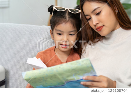 Travel Planning. A mother and daughter reviewing a map, excited for their upcoming trip. Travel Planning. A mother and daughter reviewing a map, excited for their upcoming trip. 129100704
