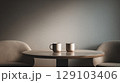 Two coffee cups sit on a round wooden table in a modern minimalist cafe, creating a peaceful atmosphere 129103406
