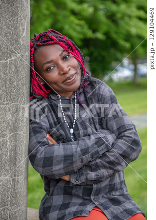 African Woman Arms Crossed Leaning Wall African Woman Arms Crossed Leaning Wall 129104469