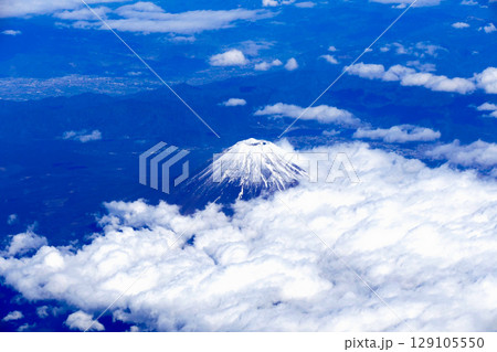 飛行機から見た雲の上に浮かぶ冠雪の富士山 129105550