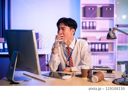 Overworked young Asian businesswoman office worker suffering from neck pain after had a long day at her office desk. Overworked young Asian businesswoman office worker suffering from neck pain after had a long day at her office desk. 129108130