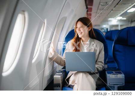 Asian Woman Working on Tablet During  in first class, multitasking with Flight Travel in style, work 129109000