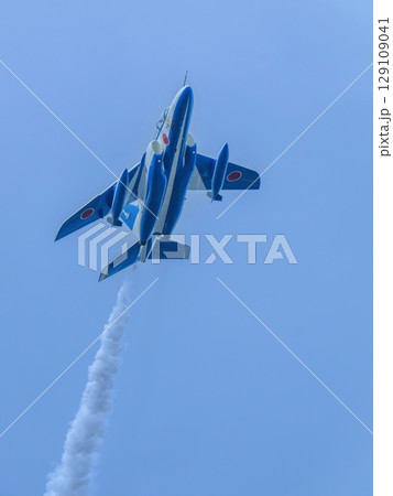 青空バックに頭上を飛ぶ戦闘機の飛翔シーン 129109041