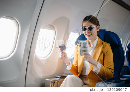 Asian Woman Working on Tablet During  in first class, multitasking with Flight Travel in style, work 129109047