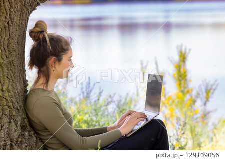Engaging in Focused Work by a Beautiful and Serene Lakeside Environment for Peaceful Productivity Engaging in Focused Work by a Beautiful and Serene Lakeside Environment for Peaceful Productivity 129109056