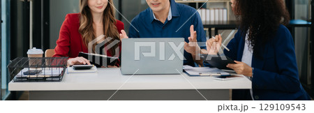 Office colleagues have a casual discussion. During a meeting in a conference room, a group of business teem sit in the conference room Office colleagues have a casual discussion. During a meeting in a conference room, a group of business teem sit in the conference room 129109543