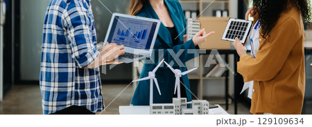 Discussion among businesspeople on the latest developments in solar cell panel technology and Solar Energy Environment city Concept. 129109634