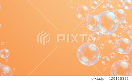 Transparent bubble cluster floating on soft orange background with light reflections creating calm and airy atmosphere 129110531