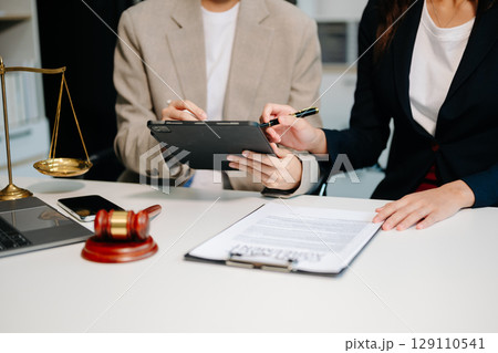 Business law concept, Lawyer business lawyers are consulting lawyers for women entrepreneurs to file copyright lawsuit with laptop and tablet 129110541