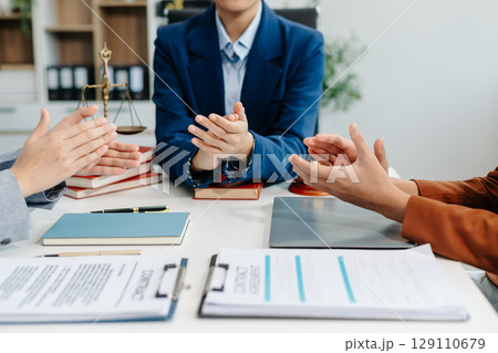 Asian team and lawyers discussing contract papers coworker, teamwork celebrating achievement.Concepts 129110679