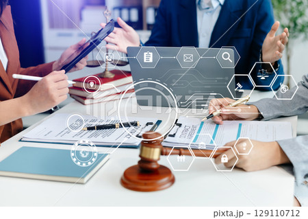 justice and law concept. Male judge in a courtroom the gavel, working with smart phone and laptop and digital tablet computer justice and law concept. Male judge in a courtroom the gavel, working with smart phone and laptop and digital tablet computer 129110712