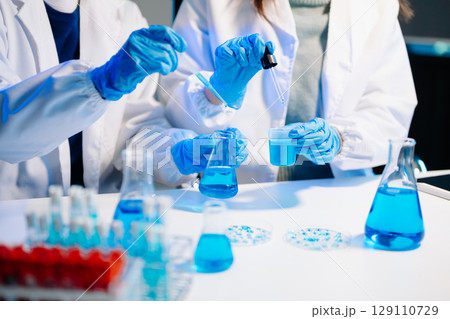 Scientist team meeting and writing analysis results in the laboratory study and analyze scientific 129110729