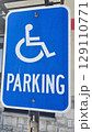blue parking sign featuring a universal symbol for accessibility and the word PARKING. Highlights the availability of designated spaces for differently disabled individuals for convenience. 129110771