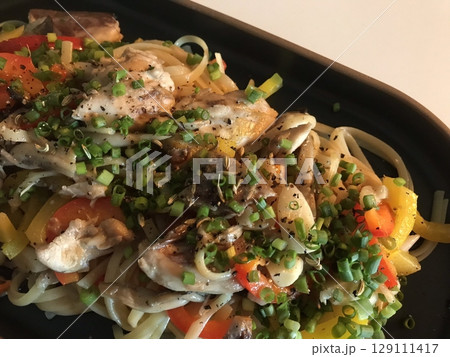 A plate of spaghetti pasta, perfectly cooked and topped with rich marinara sauce and fresh herbs. Ideal for food photography and menus, capturing the heart of Italian cuisine in a delicious way. 129111417