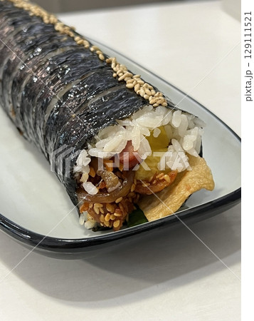 Delicious kimbap rolls filled with fresh vegetables, seasoned rice, and savory proteins, all wrapped in crisp seaweed. A perfect combination of flavor and texture in every bite. 129111521