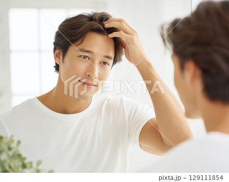 スキンケア・ヘアケアに取り組む男性のビジュアル 129111854